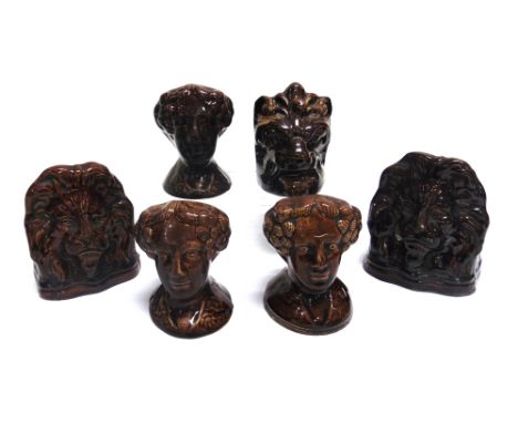A GROUP OF SIX 19TH CENTURY TREACLE GLAZE SASH WINDOW STOPS  including a pair modelled as lions 13cm high, and another 11cm h