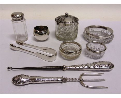 A COLLECTION OF SILVER ITEMS  comprising Victorian sugar tongs; two glass jars with silver covers; a pair of glass salts with