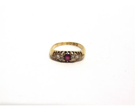 AN EDWARDIAN RUBY AND DIAMOND RING Birmingham 1906, the centre ruby flanked either side by five old cut diamonds, finger size