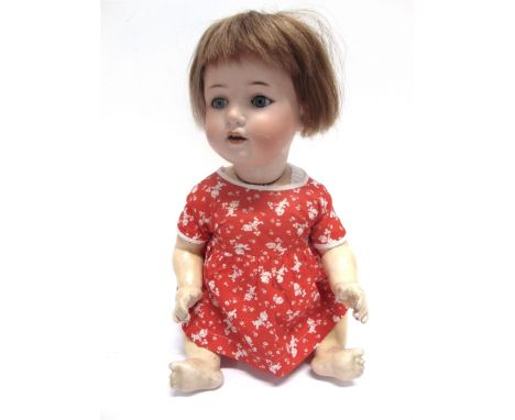 A WELSCH & CO. BISQUE SOCKET HEAD DOLL  with a cropped light brown wig, sleeping blue glass eyes and an open mouth with two u