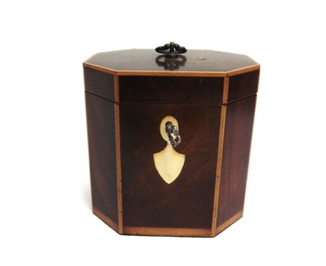 AN OCTAGONAL MAHOGANY TEA CADDY  with twin divisions to interior, 12cm wide 13cm high