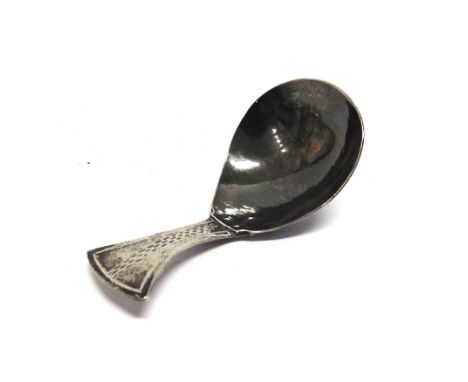 BERNARD CUZNER, A SILVER CADDY SPOON  unmarked, the deep bowl to an engraved tab handle, 8cm long, 21g gross.  This was made 