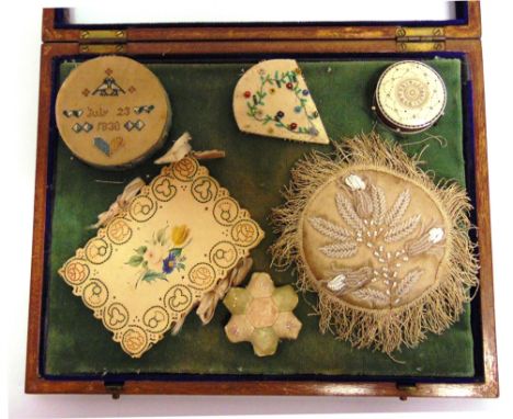 ASSORTED 19TH CENTURY SEWING ACCESSORIES  comprising pin wheels, including one with a sampler top dated 1830; pin cushions; a