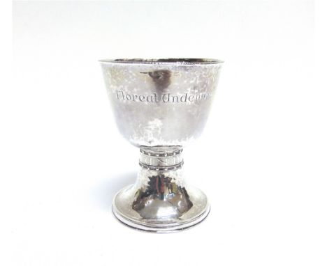 A SILVER CHALICE  by Bernard Cuzner, Birmingham 1914, the spot hammered tapering bowl inscribed 'Floreat Undelinem', the broa