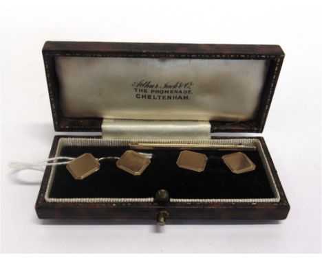 A PAIR OF 9 CARAT GOLD CUFFLINKS  Birmingham 1954, the square cut corner engine turned panels with chain connection, 1cm squa