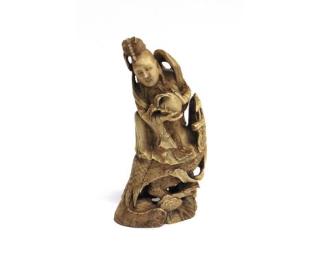 A 19TH CENTURY CHINESE CARVED IVORY TUSK  finely carved as a deity holding a peach, riding a cockerel, 14.5cm high 