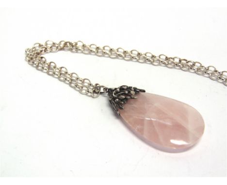 A ROSE QUARTZ PENDANT  with a leaf and tendril surmount in the style of Bernard Instone, 5.7cm long; on a later oval belcher 