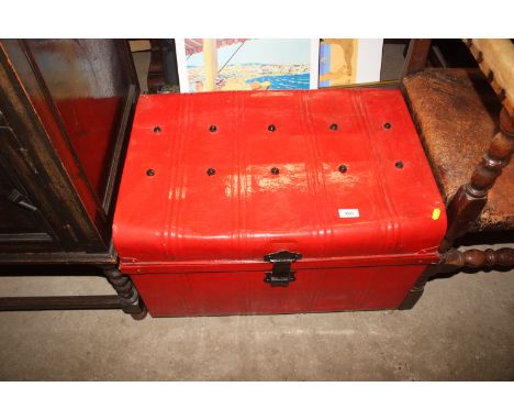 A red painted tin trunk