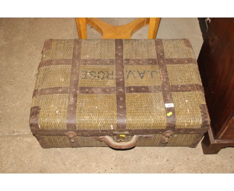 An Oriental cane trunk with metal banding and original printed cotton lining 