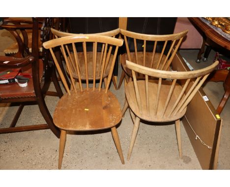 A set of four Ercol stick back dining chairs 