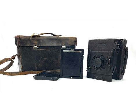 THE ‘HOUGHTON’ 1/4 PLATE FOLDING REFLEX CAMERA, with bellows action, Tessar 1:4.5 R150mm lens, contained in a morocco bound c