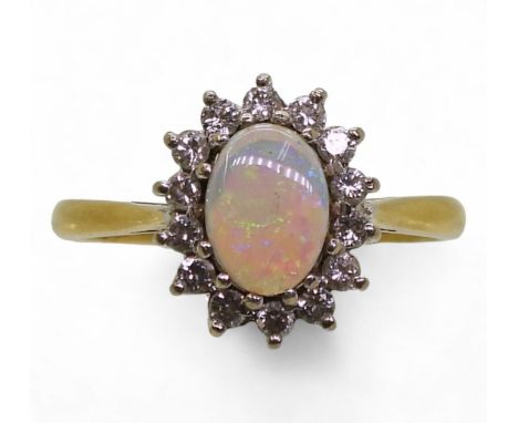A bright yellow metal opal and diamond cluster ring, set with estimated approx 0.20cts of brilliant cut diamonds, finger size