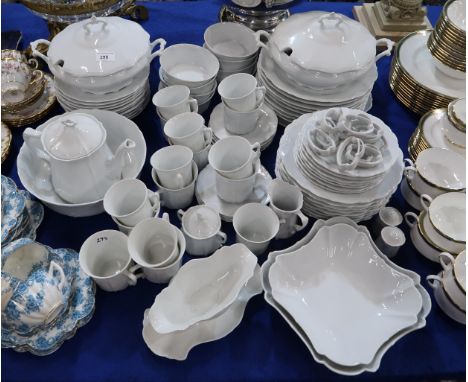 A German Hutschenreuther porcelain dinner service with moulded detail comprising pates, tureens, cups and saucers, bowls, dis