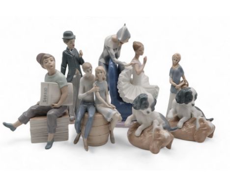 A Nao figure of a ballerina and jester, a Llladro figure of Charlie Chaplin, two Nao playing dog groups, another with a boy h