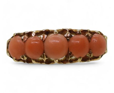 An 18ct coral ring&nbsp;with Glasgow hallmarks for 1883, set with five corals to the classic scroll mount. Size O, weight 4.6