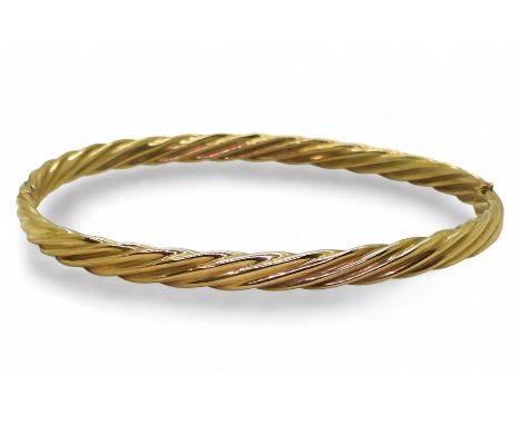 A 9ct gold twist pattern bangle, inner diameter 6cm, weight 6.4gms Condition Report:Available upon request