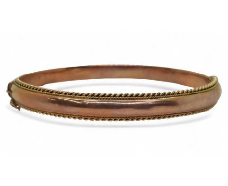 A 9ct rose gold bangle with twisted wire work detail, hallmarked Chester 1913, inner diameter 6cm, weight 8.4gms Condition Re