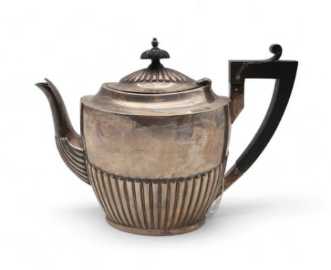 A late-Victorian silver teapot, by Walker &amp; Hall, Sheffield 1900, the body fluted,with an ebonised wooden handle, 393gms 