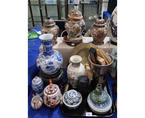 A collection of oriental ceramics including two blue and white crackleware bowls and coverts, a resin travelling shrine, blue