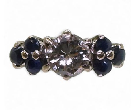 An 18ct white gold sapphire and diamond ring, set with an estimated approx 0.30cts brilliant cut diamonds, with trios of sapp