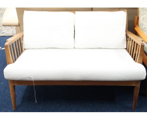 A mid 20th century teak framed George Stone, Chiltern High Wycombe rail back two seater settee with shaped arms over tapering