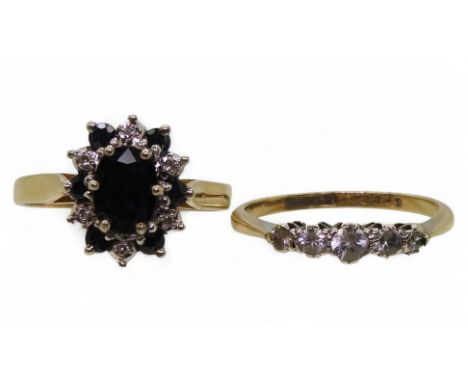 A 9ct gold sapphire and diamond cluster ring, size R1/2, and a 9ct gold five clear gem ring, size O1/2, weight 5.6gms Conditi