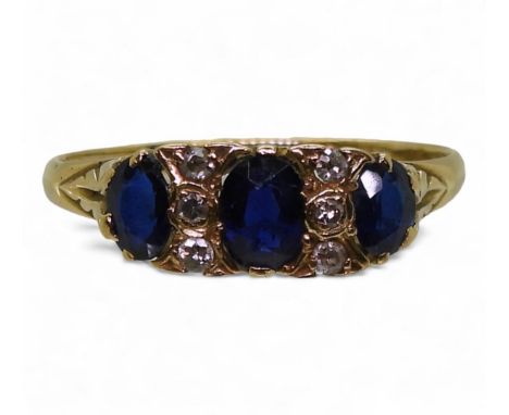A bright yellow metal blue gem and diamond ring with a scroll mount, size R1/2, weight 2.2gms Condition Report:Available upon