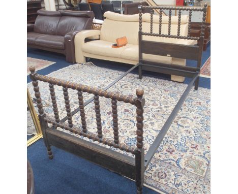 A late 19th/early 20th century oak Heal &amp; Son London single bed with turned bobbin head and foot board, 119cm high x 92cm