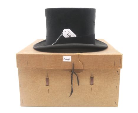 A silk top hat by Dunn &amp; Co., of small proportions (internal label reading "210 658"), in its original box; together with