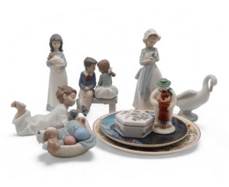 A collection of Nao figures including girl holding puppy, dog, Royal Doulton Thank You Snowman, a Franklin Mint plate, a Wedg