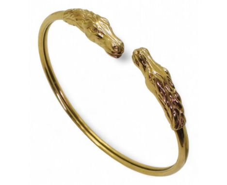 A 9ct gold bangle with horses head terminals, weight 9.9gms Condition Report:Available upon request