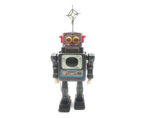 An ALPS&nbsp;Television Spaceman UM-1 battery-operated tinplate robot, together with a clockwork lift garage (2) Condition Re