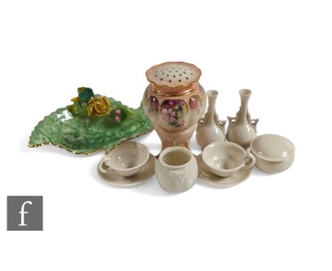 A pair of blanc de chine miniature vases, Royal Worcester shapes, together with a pair of Hadley's Worcester miniature tea cu