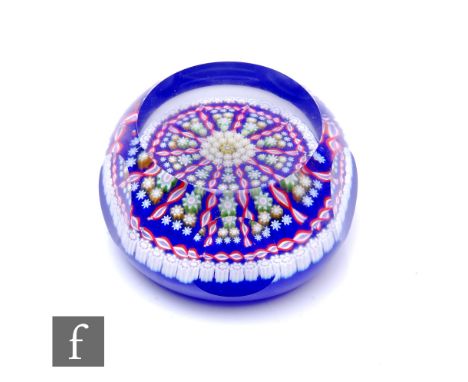 A later 20th Century Perthshire glass paperweight, internally decorated with two concentric circles of white and pale yellow 