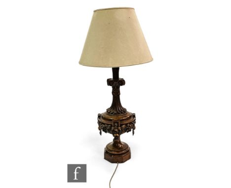 A large 20th Century carved walnut table lamp, scroll capital mount over a fruiting turned octagonal base with shade, height 