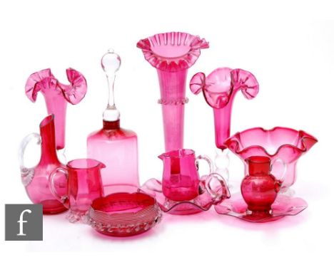 A collection of late 19th to early 20th Century ruby or cranberry glass to include frill rim vases with applied clear crystal