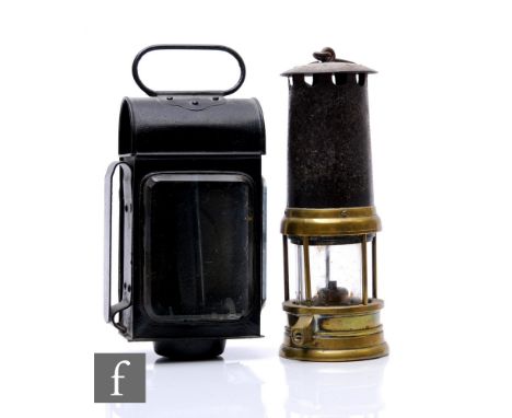 A late 19th Century brass miner's gas lamp, height 22cm, and a black carriage lamp with spring loaded candle, height 34cm. (2