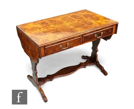 A George II style crossbanded walnut drop flap sofa table, fitted with two frieze drawers on shaped ends united by an underti