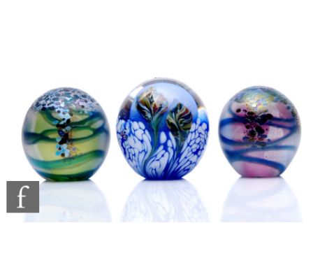 Three contemporary Jonathan Harris studio glass paperweights, including two Monet weights, mottled iridescent stylised foliag