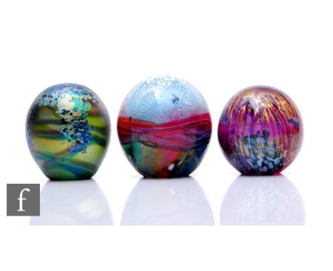 Three contemporary Jonathan Harris studio glass paperweights, including a Monet glass weight with iridised stylised waterlily