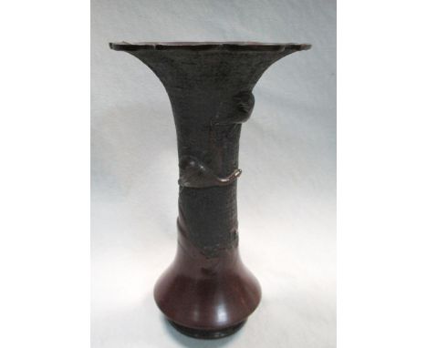 A late 19th/early 20th century bronze vase, the flaring petal edged rim above two cranes in relief flying on a daodieh ground