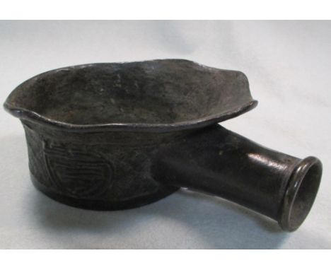 A 19th century bronze clothes iron, the rim peaking over the handle socket, the body cast with three shou roundels on a diamo