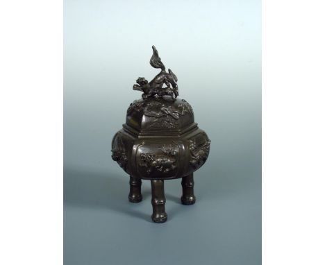 A late 19th/early 20th century bronze censer and cover, the latter with lioness and cub finial and relief band of birds among