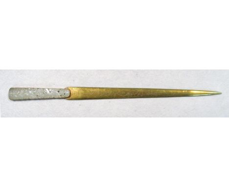 A 19th century brocade boxed jade handled brass paper knife, the blade engraved with flowering vine, the handle pierced and c