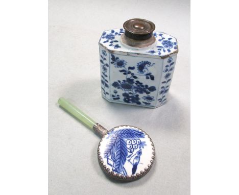 An 18th century blue and white tea caddy together with a modern hand mirror, the caddy painted with panels of flowers, the ba