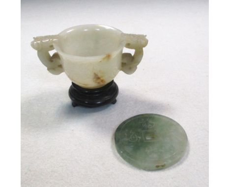 A jade two handled censer, wood stand together with a jade bi, the sides of the censer line carved with flowers within dragon