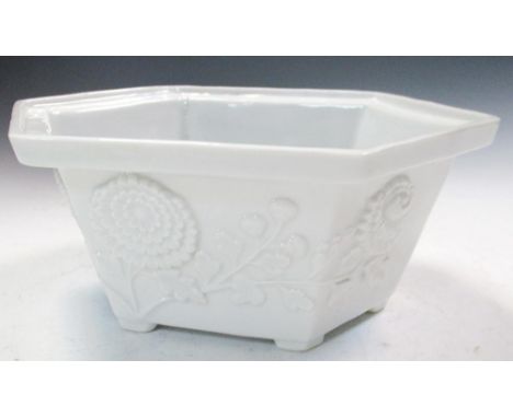 An 18th century blanc de Chine hexagonal bowl and a rectangular censor, the rim of the bowl projecting over tapering sides wi