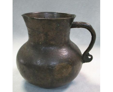 A Han dynasty bronze mug, the upper terminal of the handle attached to the flaring cylindrical rim, the lower ending with a r