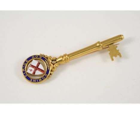 AN 18CT. GOLD AND ENAMEL PRESENTATION KEY mounted with the Coat of Arms for the City of London, and inscribed with the latin 