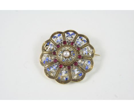 AN ENAMEL AND GOLD BROOCH the circular openwork design is centred with a half pearl within a surround of small rubies, with b